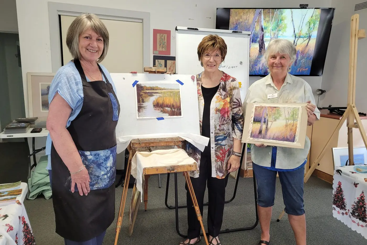 CREATIVELY FOCUSED: U3A member, Scribbler tutor and participant Deb Borleis (left) with her work, artist Jennifer Paul and U3A and Scribblers\\u2019 group member Kylli Vasey at a workshop earlier this year. PHOTO: Coral Cooksley 