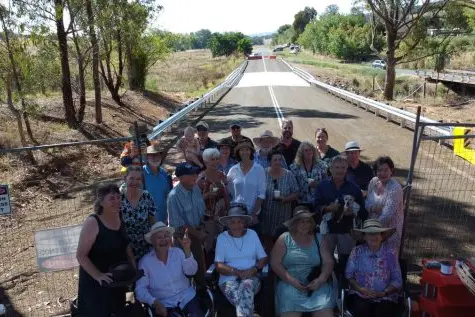 HAPPY DAYS: Indigo Valley residents gathered at the site of the new Indigo Creek Road bridge prior to its opening last Wednesday night.