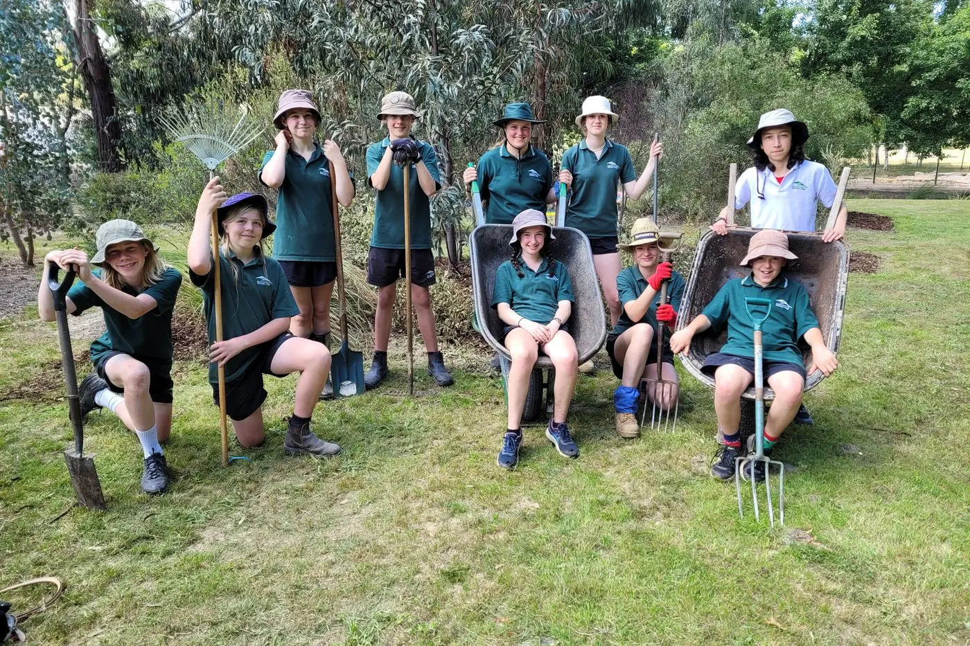 CHIPPED IN: BSC students Charlie McLachlan (left), Charles Wallen, Jalani Hemmerling, Angus Oldmeadow, Heidi Ramsay, Millie Rivers, Lib Ramsay, Ocean Mclean, Eva Doyle in the barrow (left) and Alistair Merritt in the other barrow at last week\\'s restoration project. PHOTO: Coral Cooksley.  Id:34705