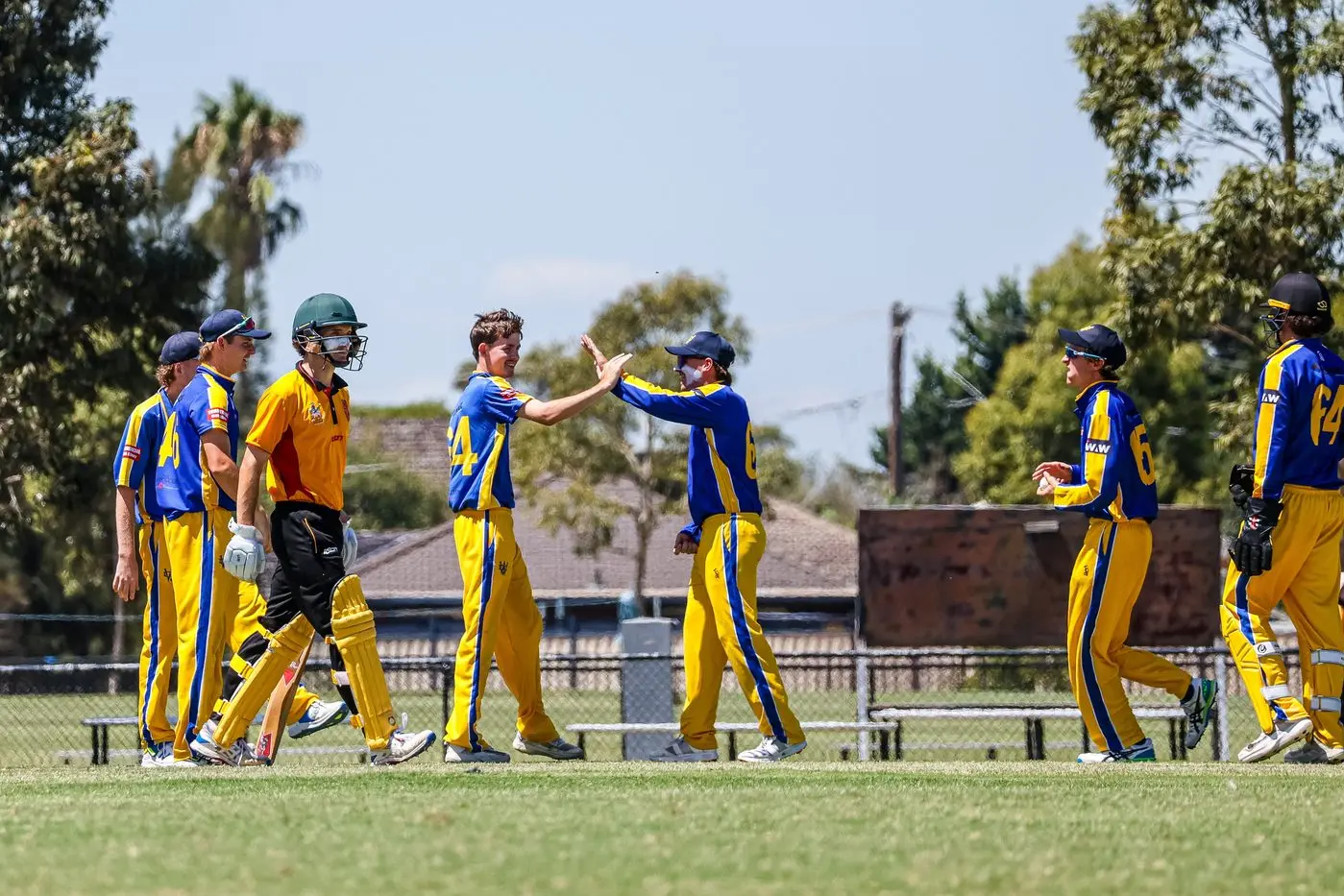 SOMETHING TO CELEBRATE: The WDCA side converges after taking a wicket at Melbourne Country Week. PHOTO: Peter Whitten