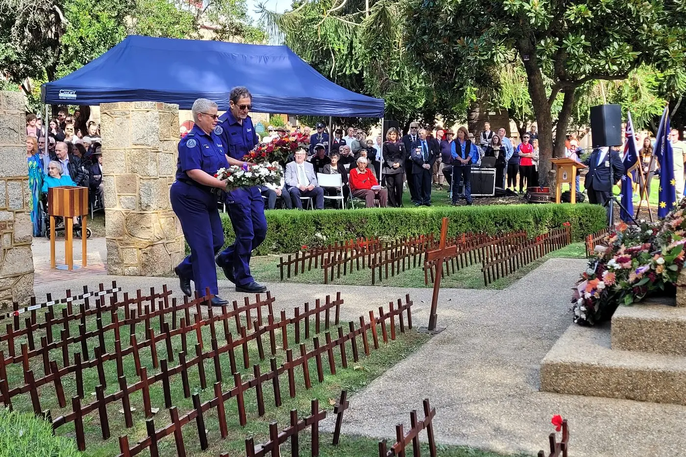 RESPECT: CFA Beechworth Urban Fire Brigade captain Tracy McVea and Beechworth Rural Fire Brigade captain Bruce Forrest laying a wreath at last year\\'s Beechworth Anzac Day Service. Photo: Coral Cooksley. Id:38980