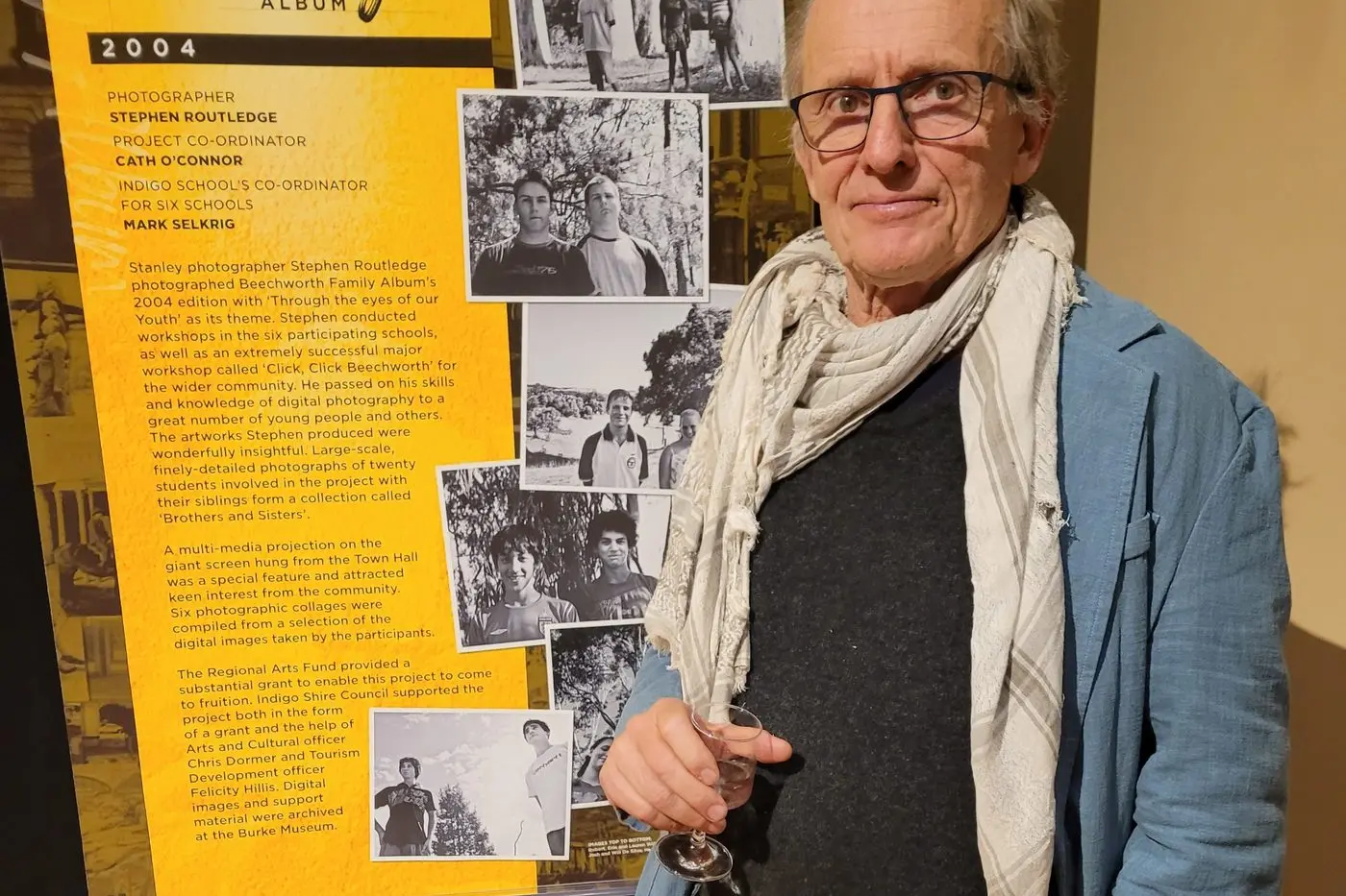INSIGHTS: Stanley photographer Stephen Routledge in front of the banner at last Thursday\\u2019s exhibition launch showcasing some of his work taken for the 2004 Family Album. PHOTOGRAPH: Coral Cooksley