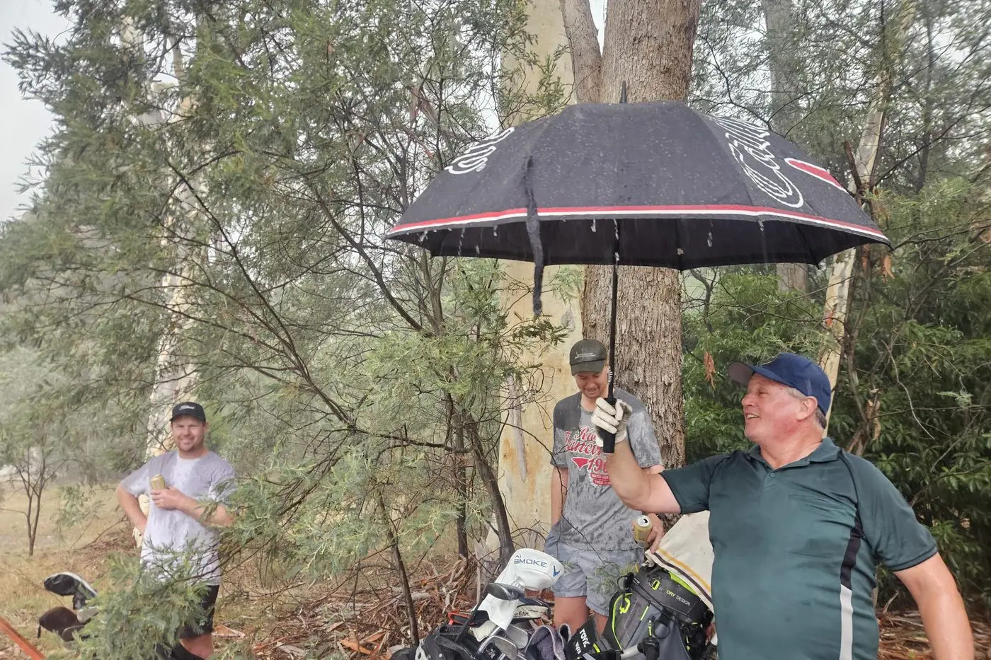 HEAVENS HAVE OPENED: Jackson Wells, Willem Love and Gerard \\'aggrandisement\\' Cull were among the golfers who braved an unexpected downpour at Beechworth last Thursday night.