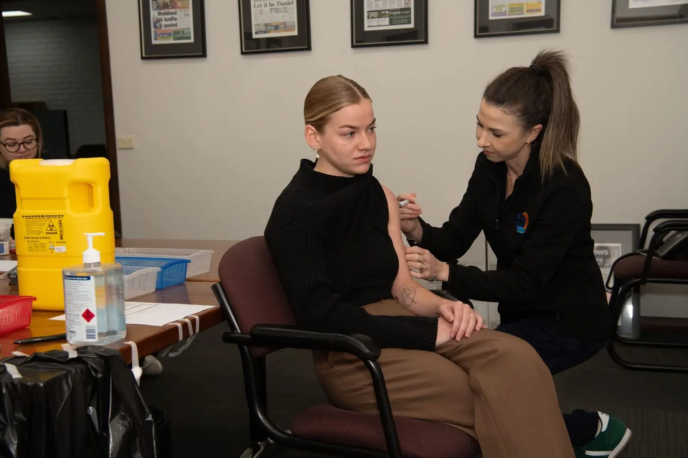OUCH: South Wangaratta Medical Clinic nurse Teresa McMahan gives Jordan Duursma a flu shot at the Wangaratta Chronicle. The clinic travels right across the municipality to businesses, helping people stay protected against the nasty influenza virus and covid.