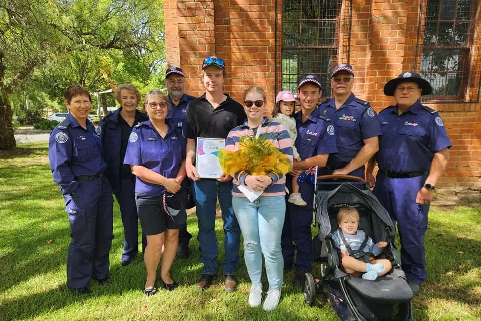 SURROUNDED BY MENTORS: Indigo Shire Young Citizen of the Year Kurt Sorenson (centre in black) was surrounded by his Chiltern CFA colleagues as he accepted the award at the town\\'s Australia Day ceremony last week. PHOTO: Chiltern CFA