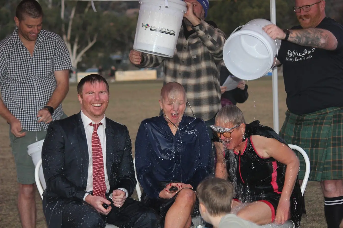 ICY COLD: Halliday Solicitors\\u2019 Matt Grogan (seated left, Beechworth Surgery\\u2019s Sue Fendyk and Quercus and Beechworth Football Netball Club volunteer Joanne Westra rendered speechless as ice bucket pourers Graeme Weldon (back left), Shaun Witherow, and Damian Jones undertake the deed. PHOTOS: Georgia O\\u2019Connor