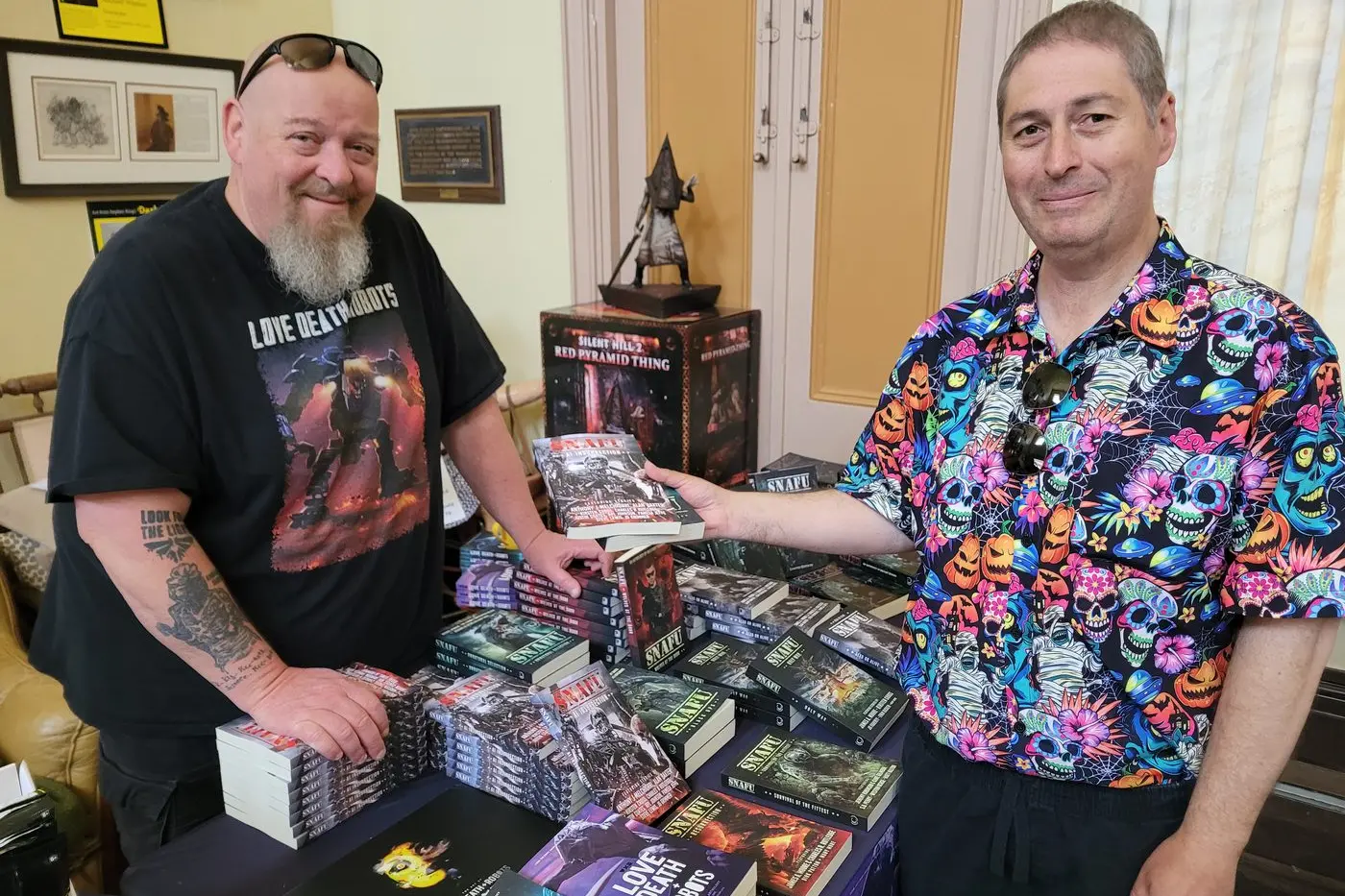 HORROR BOOK LOVER: Wagga Wagga\\u2019s Dion Smith (right) grabbed some books from Asylumfest organiser Geoff Brown at the end of last month. PHOTO: Coral Cooksley