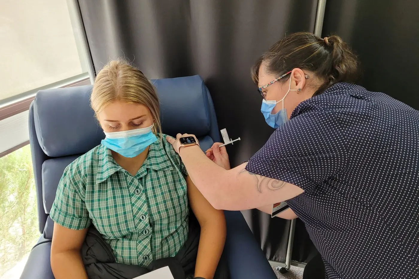JAB: Beechworth Secondary College Year 12 student Elijah Holding received a shot in the arm with Pfizer vaccine by vaccinator Katherine Porter at the BHS hub in September. PHOTO: Coral Cooksley