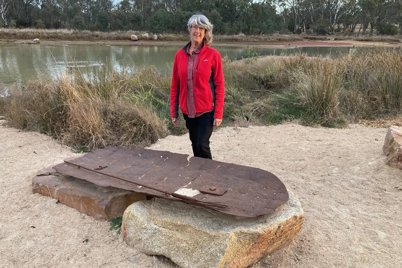 TRIBUTE: ArtsRutherglen member Gail Steed standing with the sculpture \"A First Nations Canoe and Pronged Fishing Spear\" by artist Lorraine Connelly-Northey. PHOTO: Coral Cooksley