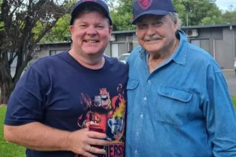 HONOUR THE LEGEND: Neil (left) and Ron Barassi celebrate the Demons\\' 2021 premiership.