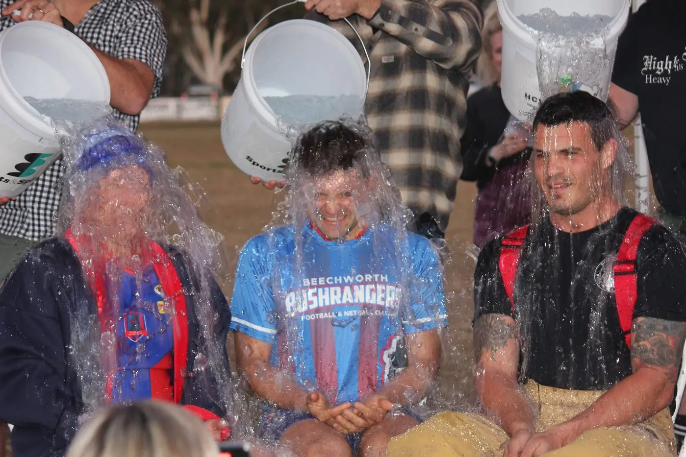 ICE PLUNGE: Brayden Carey, Cam Fendyk and Brendon took part in the ice bucket challenge at the Beechworth Football Netball Club\\'s Family Fun Day. 
