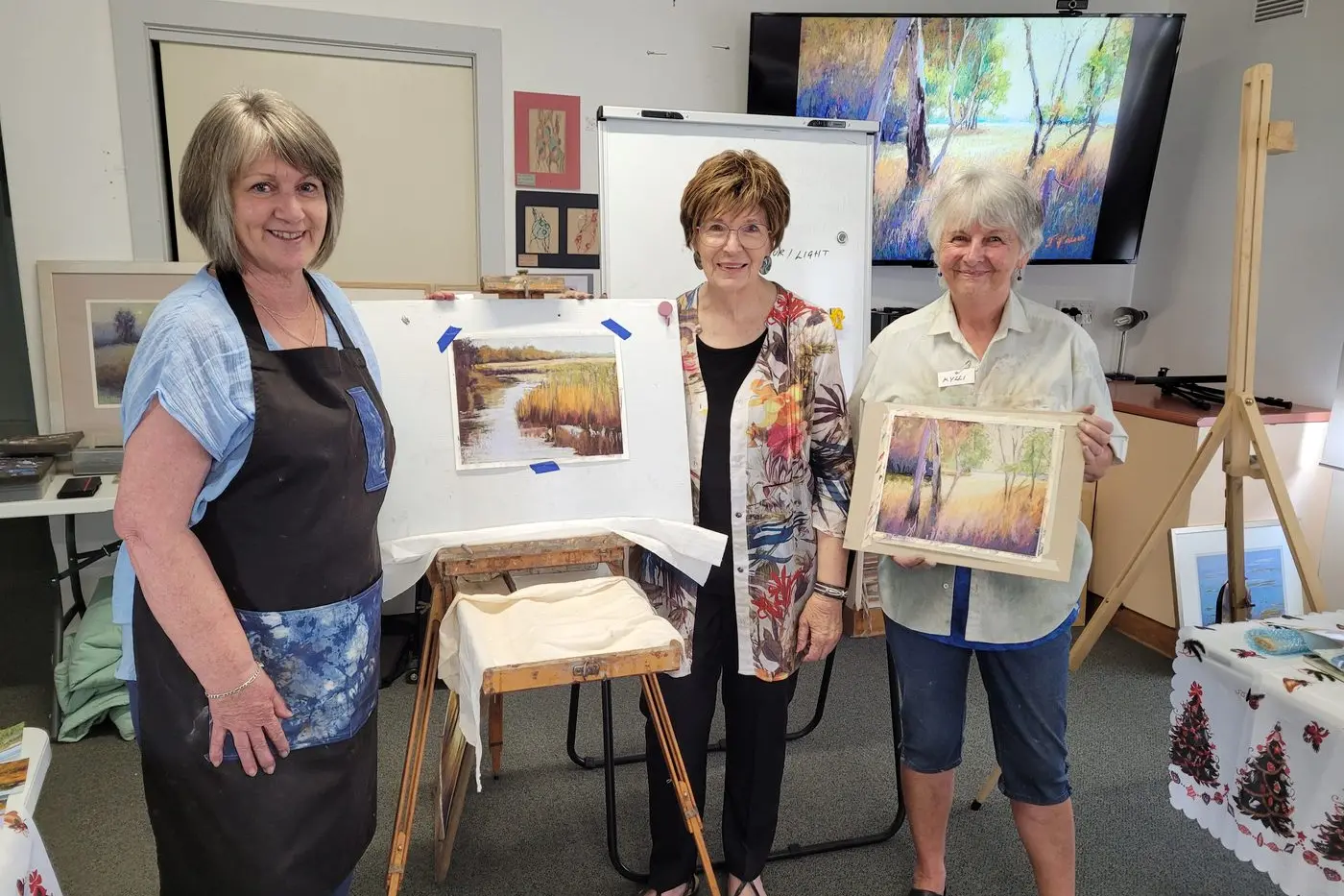 CREATIVELY FOCUSED: U3A member, Scribbler tutor and participant Deb Borleis (left) with her work, artist Jennifer Paull with U3A and Scribblers\\u2019 group member Kylli Vasey with her work at this week\\u2019s workshop. PHOTO: Coral Cooksley