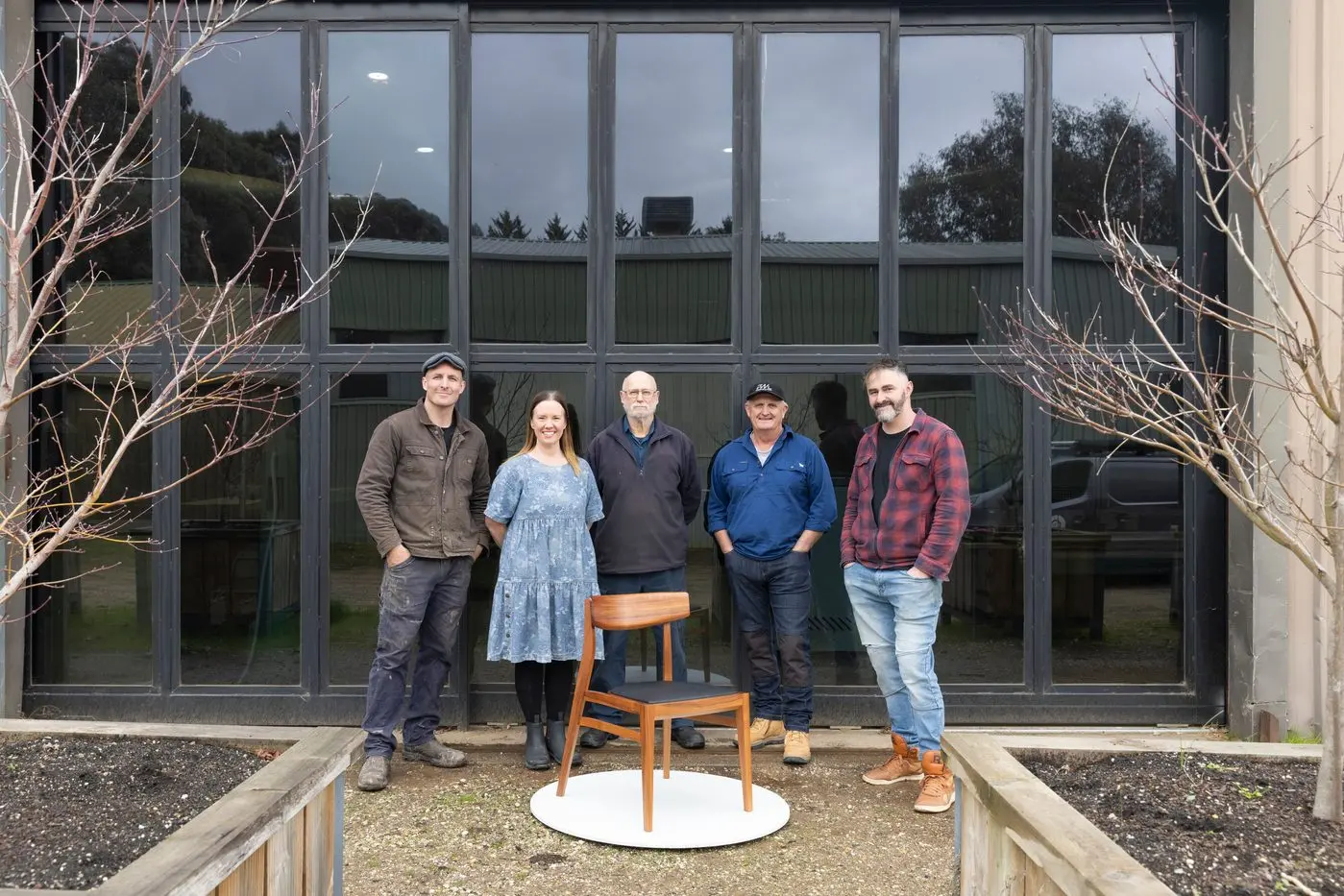 THE A TEAM: Pictured with one of the dining room chairs made for the Speaker of the Victorian Parliament are (from right to left) Ben Saunier (Domestic and commercial upholsterer at Eightpastfive Upholstery, Porepunkah) Rob Love (furniture polisher at Furnlac, Bright), Denis Brown (timber miller, dryer and marketer at Corsair Sustainable Timbers, Yackandandah), and Louise and Elliot Gorham (Steel Road Custom Furniture, Yackandandah). PHOTOS: Michael Gordon Hill
