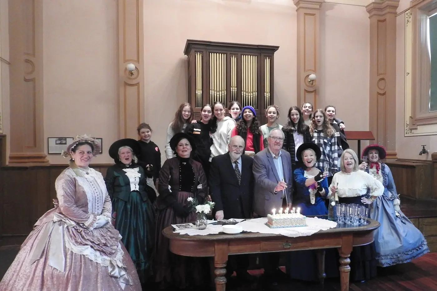 PARTY TIME: Indigo Shire Mayor Bernard Gaffney cutting the cake at the Beechworth Town Hall organ\\'s 170th birthday celebration with Katherine Waugh, Ute Jeffcott, Sharon Kurrule , Sandra Williams, Heidi Freeman and students from the CGI Youth Camp Group from Melbourne. PHOTO: Mark Stephens Id:27641
