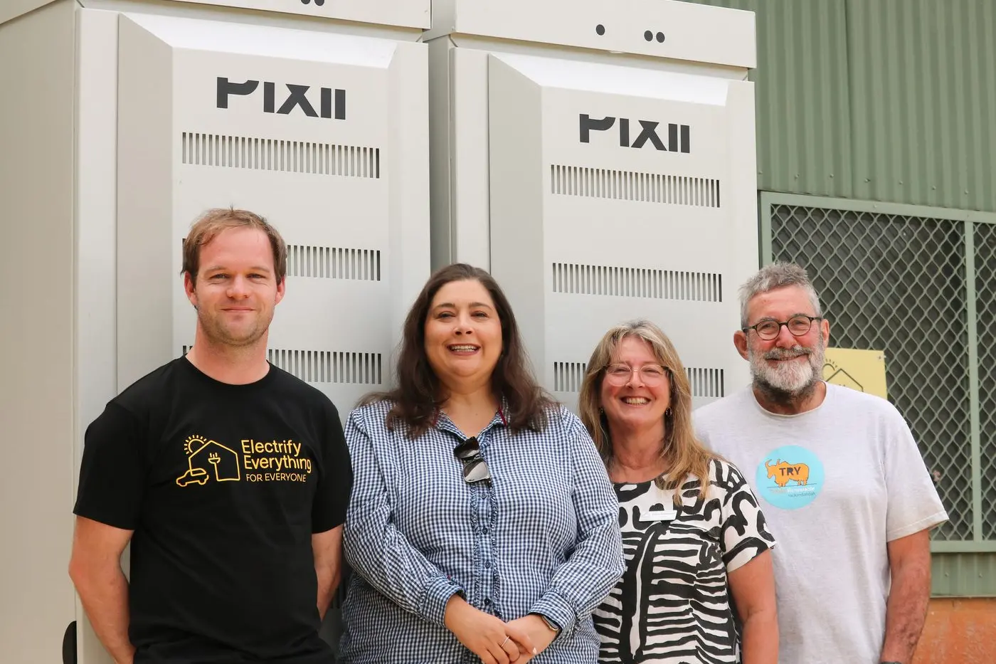 FULLY CHARGED: TRY committee members Blake Edwards (left) and Mark Parnell (far right),\\tVictorian Parliamentary secretary for Climate Action, Sheena Watt (centre left) and Di Shepheard, Indigo Shire Council (centre right) in front of Yackandandah\\'s fully charged second battery.\\n
