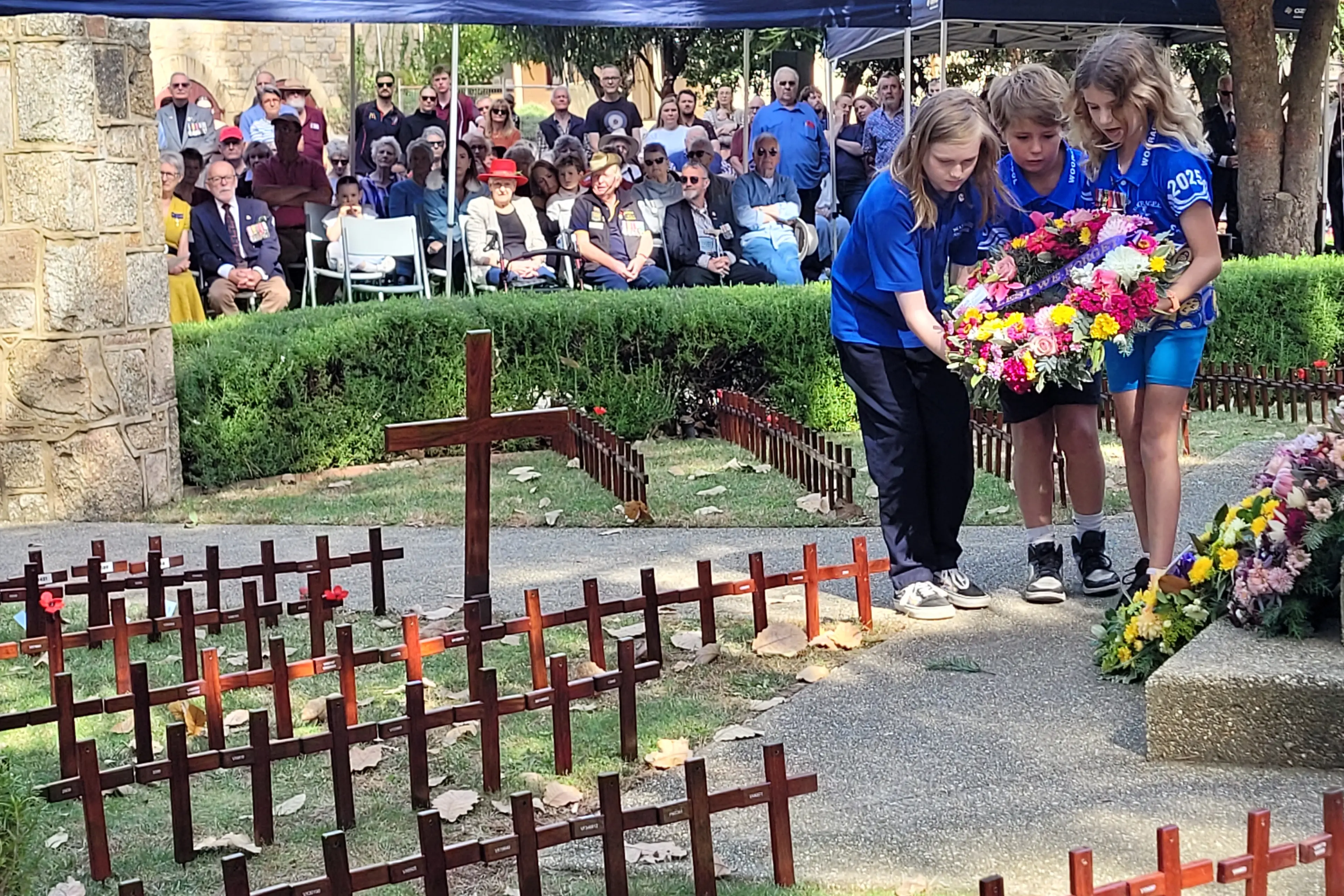 <p>LEST WE FORGET: Wooragee Primary School students James, Hudson and Zara placed a wreath on behalf of their school at last year\\u2019s ANZAC Day service in Beechworth. PHOTO: Coral Cooksley</p>\\n