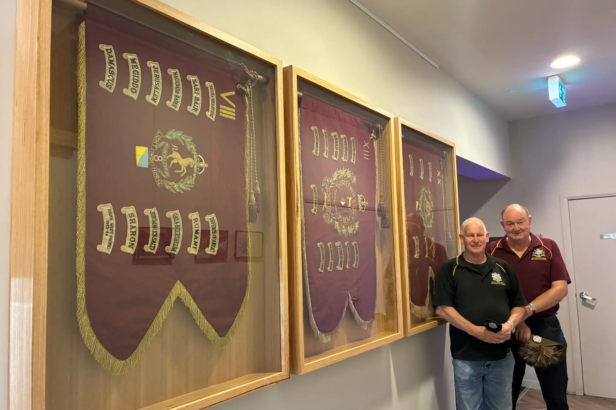 <p>HUNG WITH PRIDE: 8/13 Victoria Mounted Rifles Association vice-president Adrian Younger and Shane Walch are inviting the community to see the newly framed and returned guidon flags of local VMR regiments which have recently been put on display at Wangaratta RSL. PHOTO: Jordan Duursma</p>\\n