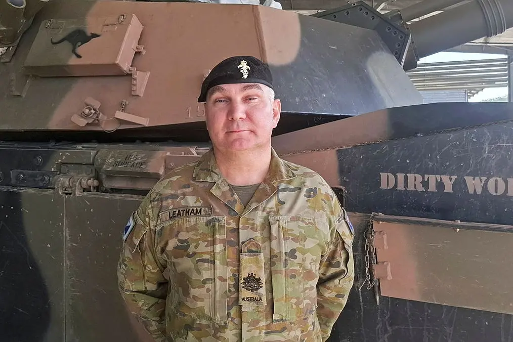 <p>CSM HONOUR: WO1 Daniel Leatham in front of a M1A2 Battle Tank at 2nd Cavalry Regiment, Lavarack Barracks, Townsville. PHOTO: Major Michael McMahon</p>\\n