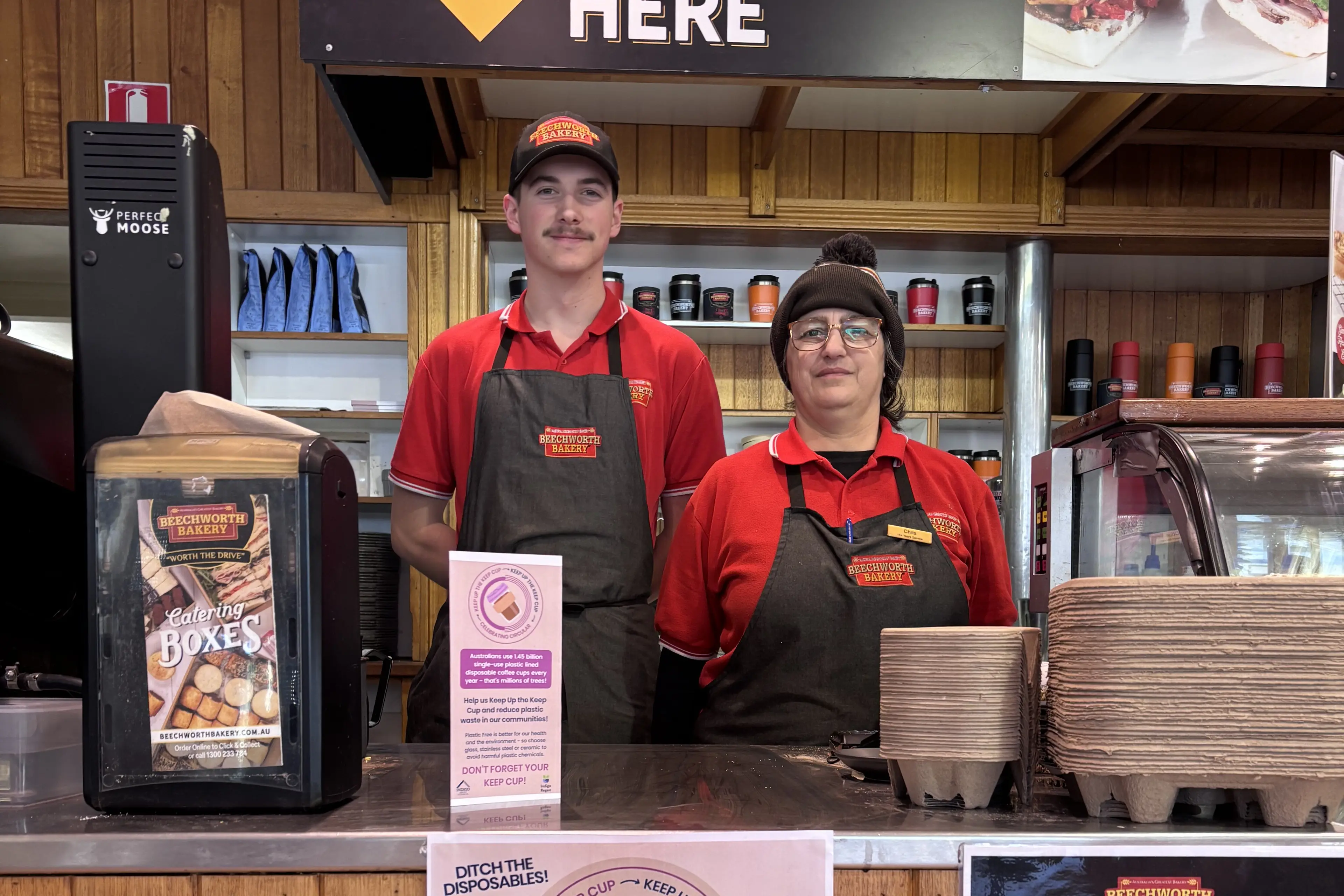 <p>ON BOARD: Beechworth Bakery\\u2019s staff Bailey Horne and Chris Bonacci with the poster encouraging customers to bring their own keep cup.</p>\\n